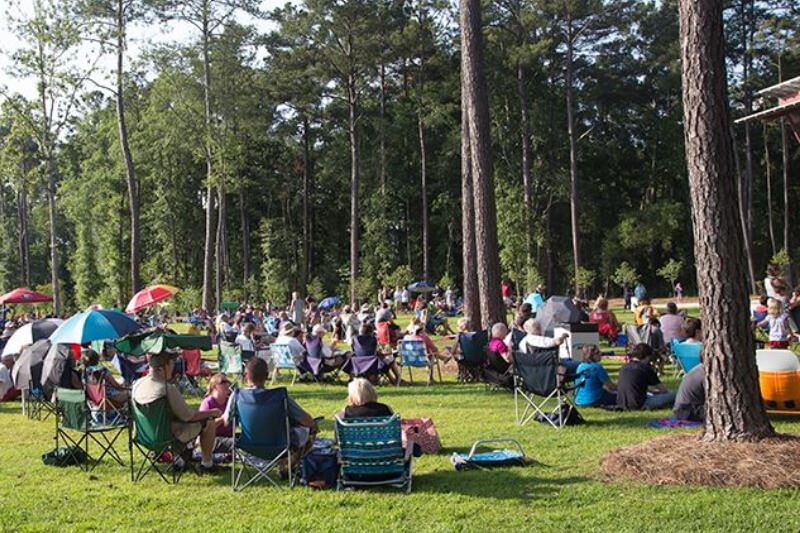 Gathering for outdoor music event in Brown Family Park in Nexton.