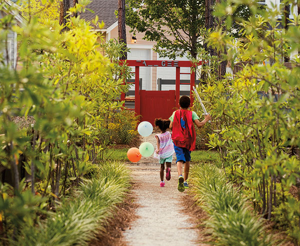 Kids running and playing in Nexton park.