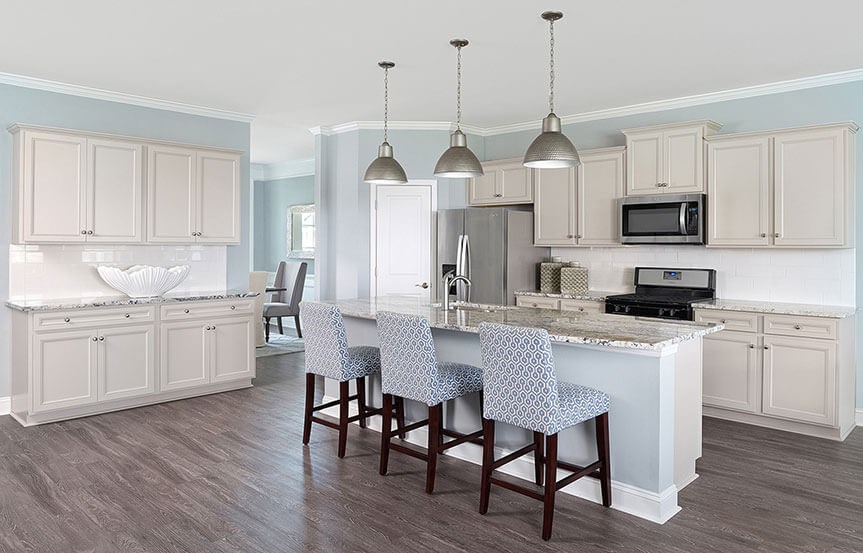 Kitchen with island and bar stools  in Mitchell model home by Centex in Nexton.