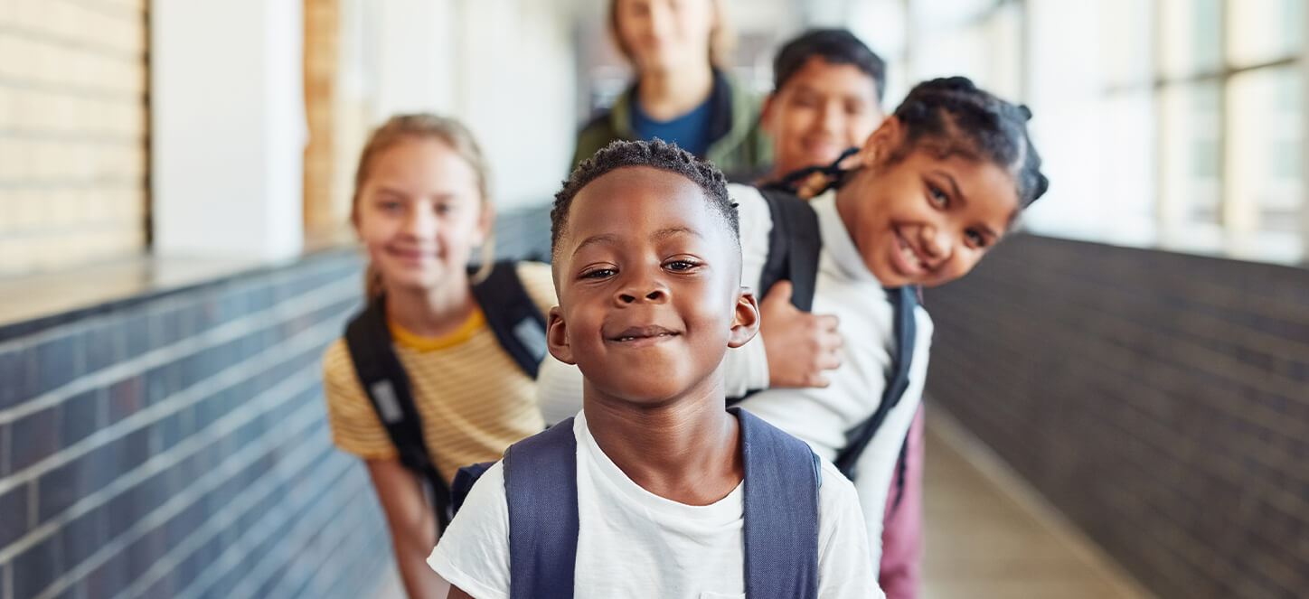 School kids smiling in hallway
