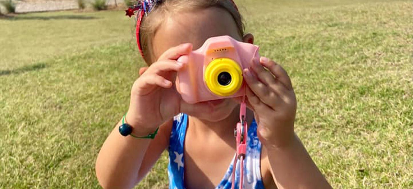 Little kid with play camera